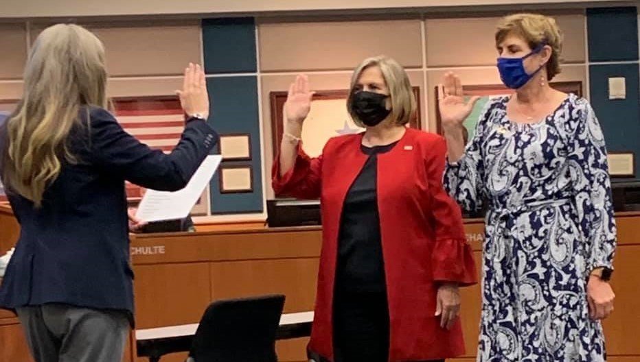 Rebecca Fox (in red) and Dawn Champagne (in print dress) were sworn in for new terms at Monday’s Katy ISD Board of Trustees meeting. Fox has previously served on the board while Champagne was reelected without a break in service as a trustee. Both have said they feel advocating for children and teachers is an important part of their role as trustees.